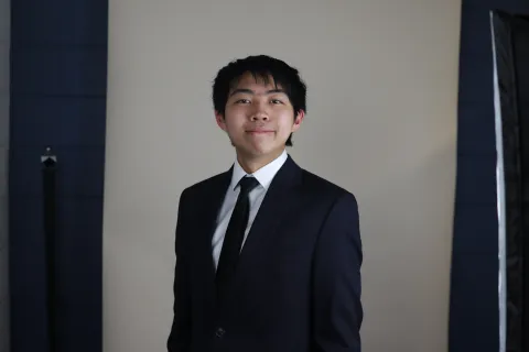 man smiling in black suit
