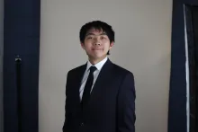man smiling in black suit